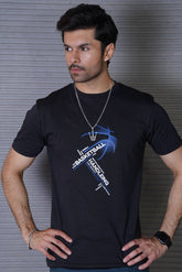 Man wearing a black t-shirt with a graphic design against a gray background